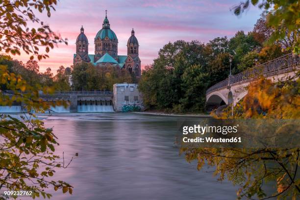 germany, bavaria, munich, river isar, prater island and st luke's church in autumn - munich autumn stock pictures, royalty-free photos & images