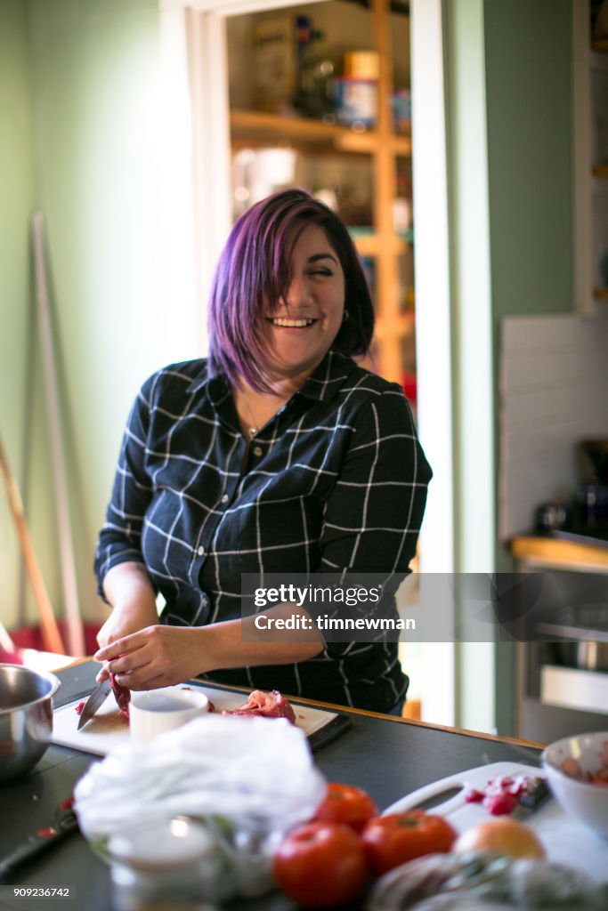 Beautiful Salvadorian Millennial Woman Cooking in Kitchen