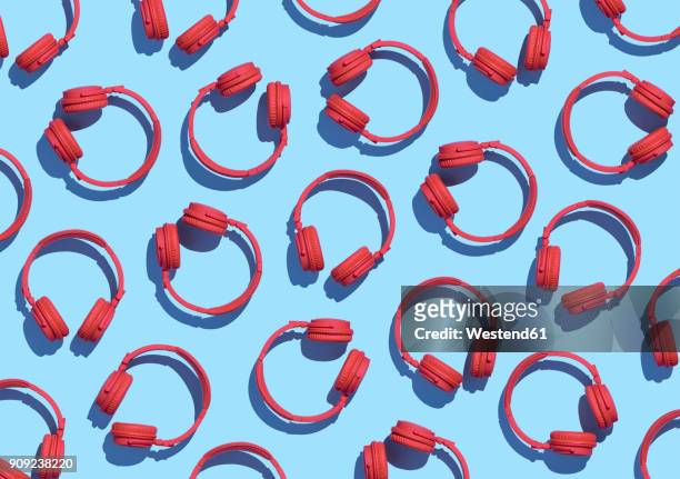 illustrazioni stock, clip art, cartoni animati e icone di tendenza di collection of red wireless headphones on light blue background, 3d rendering - sfondo a colori