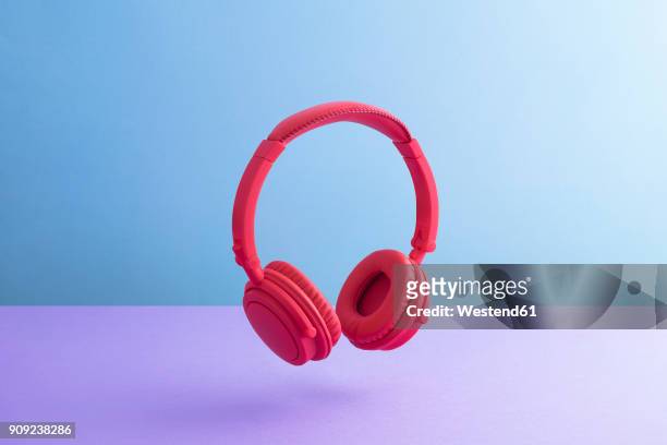 red wireless headphones - earbud stock pictures, royalty-free photos & images