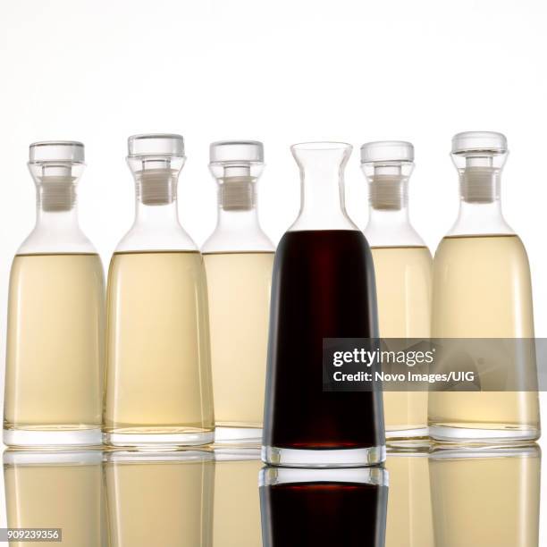 bottled light and dark vinegar on white background - white vinegar stock pictures, royalty-free photos & images