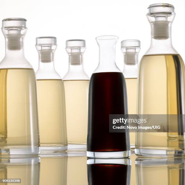 bottled light and dark vinegar on white background - white vinegar stock pictures, royalty-free photos & images