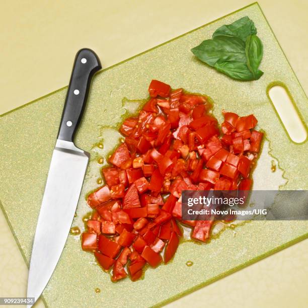 diced tomatoes with basil and sharp knife on cutting board, high angle view - sharp angle stock pictures, royalty-free photos & images