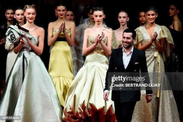 French fashion designer Alexis Mabille acknowledges the audience at the end of the 2018 spring/summer Haute Couture collection fashion show on...