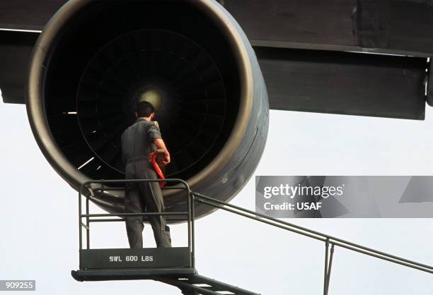 Crew chief inspects an engine of a 436th Military Airlift Wing C-5A Galaxy aircraft at Freetown International Airport prior to the plane's flight to...