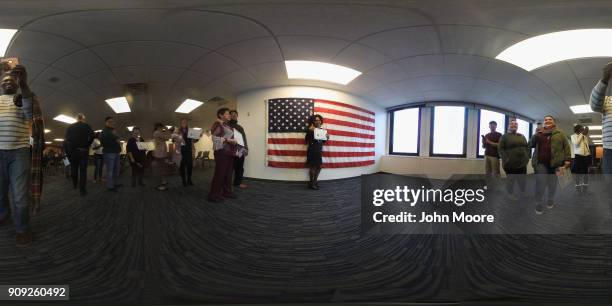 New American citizens pose for photos following a naturalization service on January 22, 2018 in Newark, New Jersey. Immigrants from 32 different...