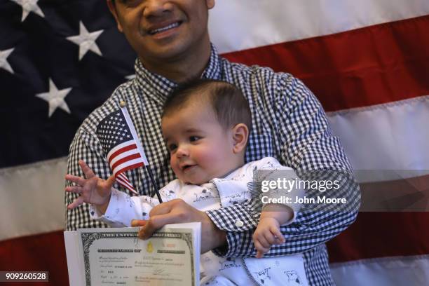 Families pose for photos following a naturalization ceremony on January 22, 2018 in Newark, New Jersey. Immigrants from 32 different countries became...