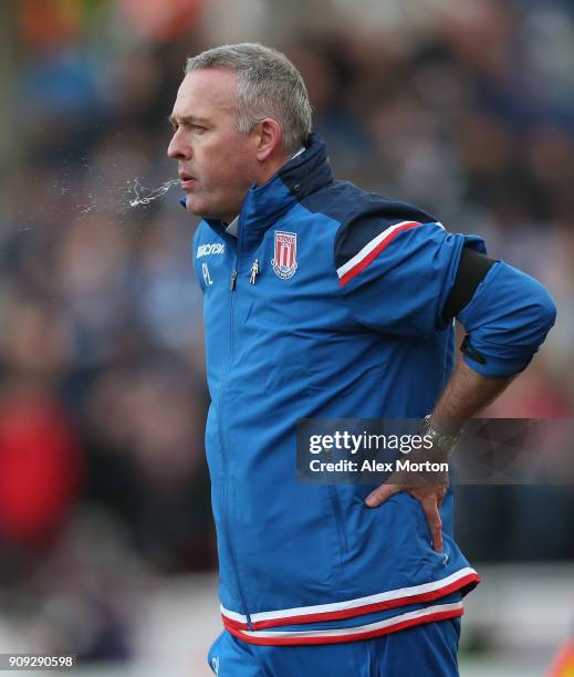 Stoke manager Paul Lambert spits during the Premier League match between Stoke City and Huddersfield Town at Bet365 Stadium on January 20, 2018 in...