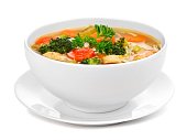 Homemade chicken vegetable soup isolated on white