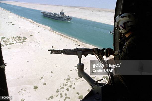 Gunner in a Anti-submarine Helicopter mans a M-60 machine gun as the nuclear-powered aircraft carrier USS Dwight D. Eisenhower transits the Suez...