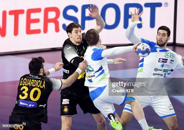 Slovenia's Miha Zarabec vies with Spain's Viran Morros de Argila and Gedeon Guardiola during the group II match of the Men's 2018 EHF European...