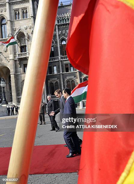 Vietnamese Prime Minister Nguyen Tan Dung walks on a red carpet as he inspects the honour guard with his Hungarian counterpart Gordon Bajnai in front...