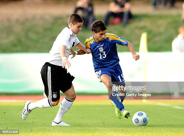 Niklas Kreuzer of Germany and Nikos Englezou of Cyprus battle for the ball during the U17 friendly international match between Germany and Cyprus at...