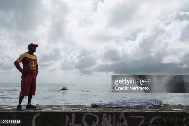 The body of the pilot Daniel Galvão is seen covered. He was rescued without life by the residents of the place, in Recife, Northeast Brazil, on...