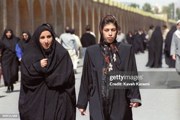 Two women in different styles of Islamic dress on the Si-o-Seh Pol bridge in Isfahan, Iran, 2nd October 1991.