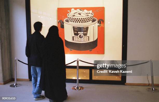 An Iranian couple viewing 'Roto Broil' - a painting by American Pop Artist Roy Lichtenstein at the Tehran Museum of Contemporary Art, 23rd September...