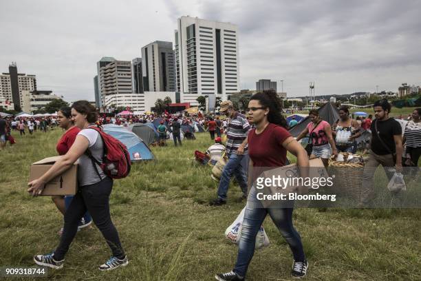 Supporters carry food and items to a Brazilian Movement of Landless Rural Workers temporary campsite ahead of former President Luiz Inacio Lula da...