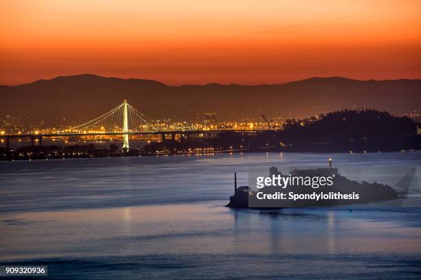 new bay bridge and alcatraz island at san francisco - alcatraz stock pictures, royalty-free photos & images