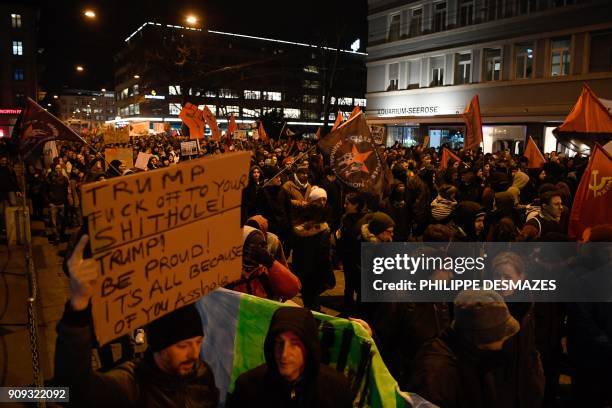 People rally as they protest against the attendance of the US president to the upcoming Davos World Economic Forum, on January 23 in central Zurich....