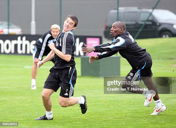 Geremi chases Joey Barton during a Newcastle United training session at The Little Benton training ground on September 18, 2009 in Newcastle, England.