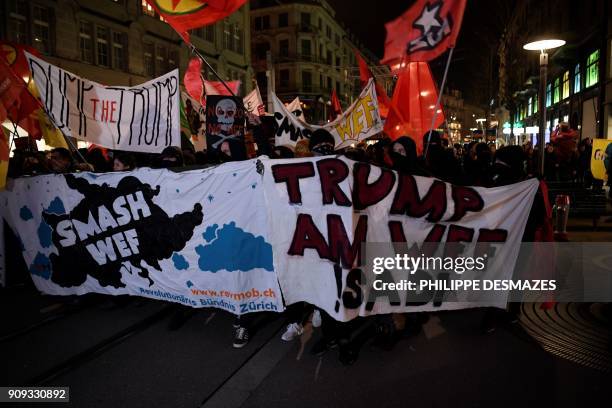 People rally as they protest against the attendance of the US president to the upcoming Davos World Economic Forum, on January 23 in central Zurich....