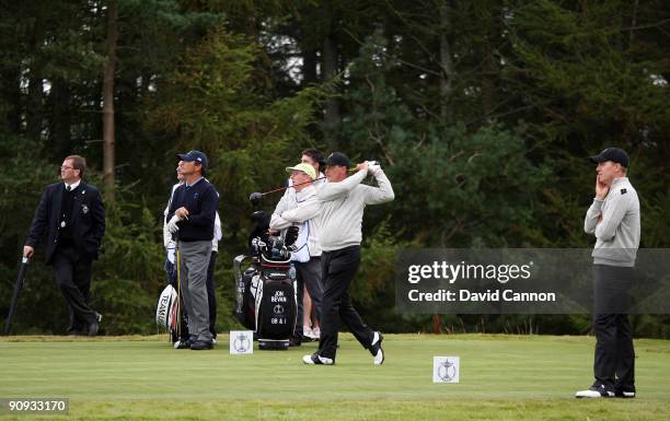 Jon Bevan of England and the Great Britain and Ireland Team tees off at the 10th watched by his partner Will Barnes in the morning foursome matches...