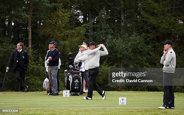 Jon Bevan of England and the Great Britain and Ireland Team tees off at the 10th watched by his partner Will Barnes in the morning foursome matches...