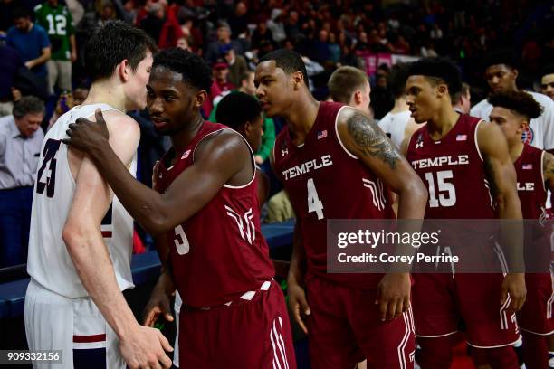 Brodeur of the Pennsylvania Quakers is hugged by Shizz Alston Jr. #3 as teammates J.P. Moorman II, Nate Pierre-Louis and Alani Moore II of the Temple...
