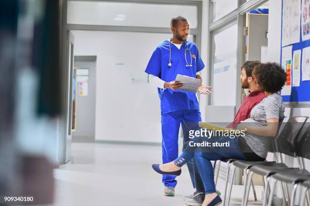 doctor chatting in corridor - maternity ward stock pictures, royalty-free photos & images