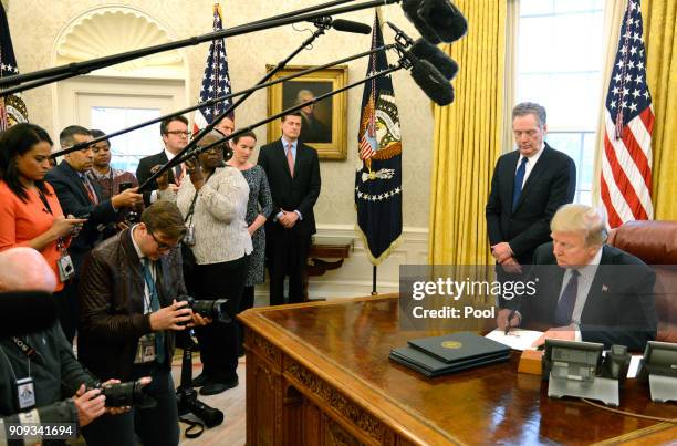 President Donald Trump makes remarks as he signs a Section 201 action as US Trade Representative Robert Lighthizer witnesses, in the Oval Office, at...