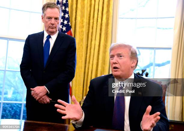 President Donald Trump makes remarks as he signs a Section 201 action as US Trade Representative Robert Lighthizer witnesses, in the Oval Office, at...