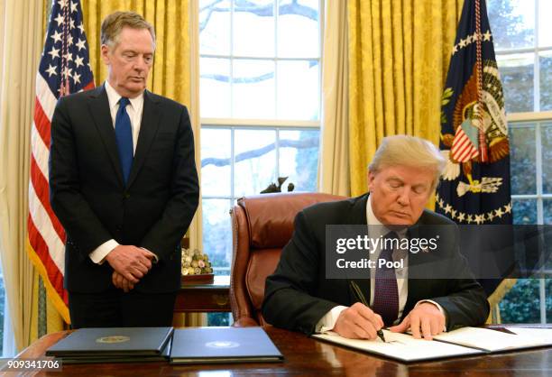 President Donald Trump makes remarks as he signs a Section 201 action as US Trade Representative Robert Lighthizer witnesses, in the Oval Office, at...