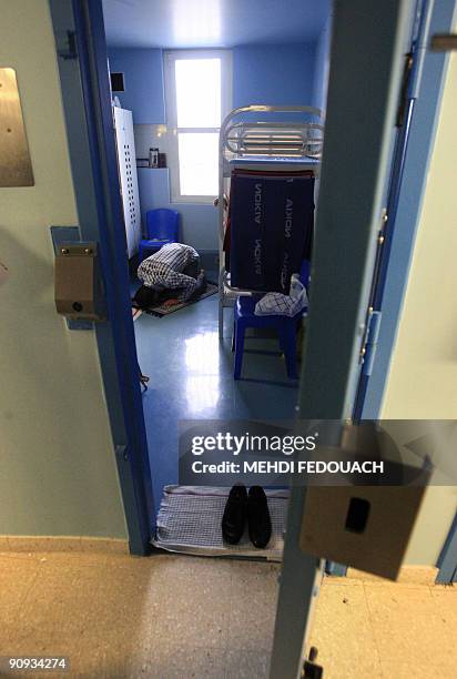 Muslim prisoner prays in his cell while packages prepared by a French Islamic relief organisation "Secours islamique" are distributed to prisoners...