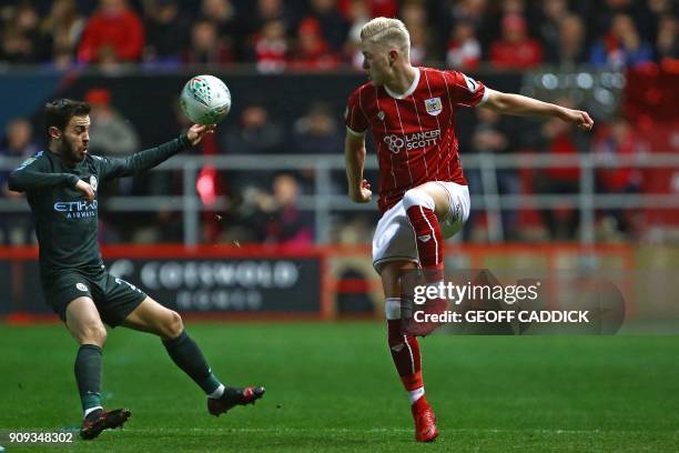 Bristol City's Icelandic defender Hordur Magnusson vies with Manchester City's Portuguese midfielder Bernardo Silva during the English League Cup...