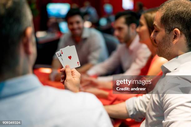 group of people playing blackjack at the casino - poker stock pictures, royalty-free photos & images