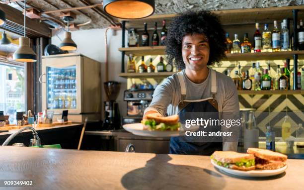 happy waiter working at a restaurant - sandwich shop stock pictures, royalty-free photos & images