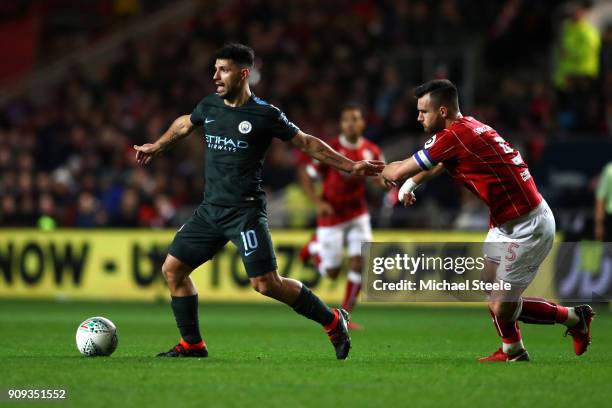 Sergio Aguero of Manchester City in action with Bailey Wright of Bristol City during the Carabao Cup semi-final second leg match between Bristol City...