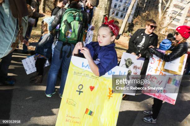 Young girl dressed as Rosie the Riveter attends the 2018 Women's March on New York City at Central Park West on January 20, 2018 in New York City.