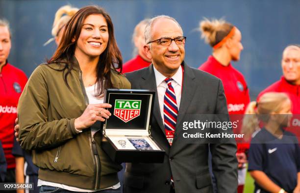 Hope Solo is presented with commemorative items honoring her 200th cap by U.S. Soccer Vice President Carlos Cordeiro the field during pregame...