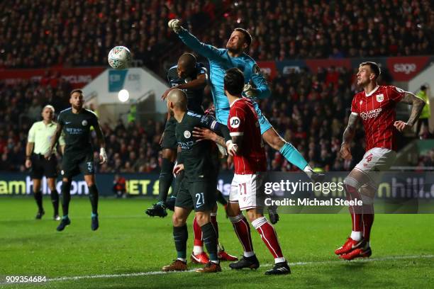 Luke Steele of Bristol City punches clear from Fernandinho of Manchester City during the Carabao Cup semi-final second leg match between Bristol City...