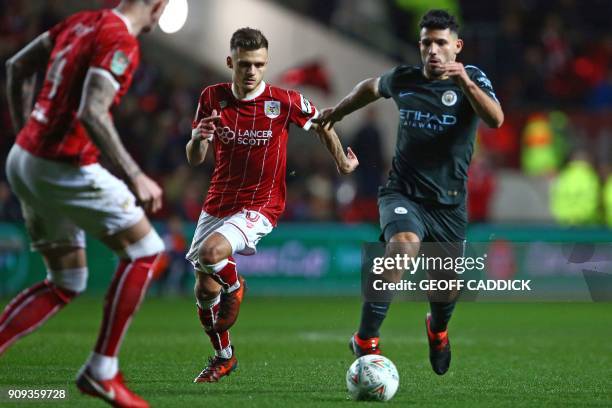 Manchester City's Argentinian striker Sergio Aguero vies with Bristol City's English midfielder Jamie Paterson during the English League Cup...