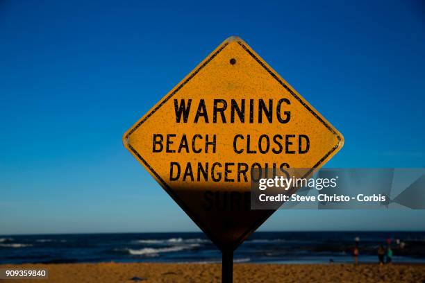 Beach Closed sign warning swimmers of the dangerous surf conditions during king tides at Mona Vale on January 18, 2018 in Sydney, Australia