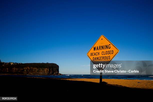 Beach Closed sign warning swimmers of the dangerous surf conditions during king tides at Mona Vale on January 18, 2018 in Sydney, Australia