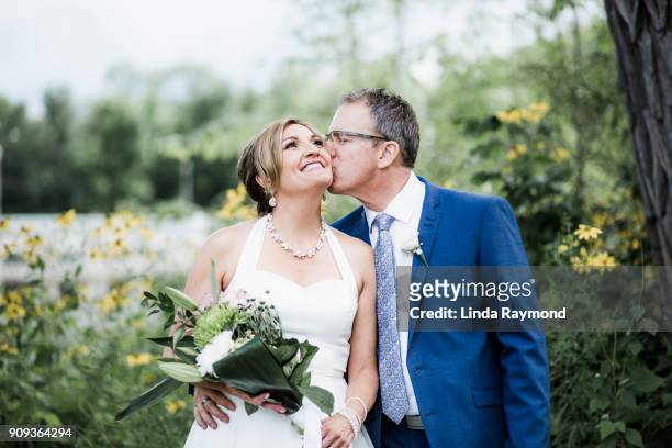 newlyweds kissing - front on groom and bride stock pictures, royalty-free photos & images