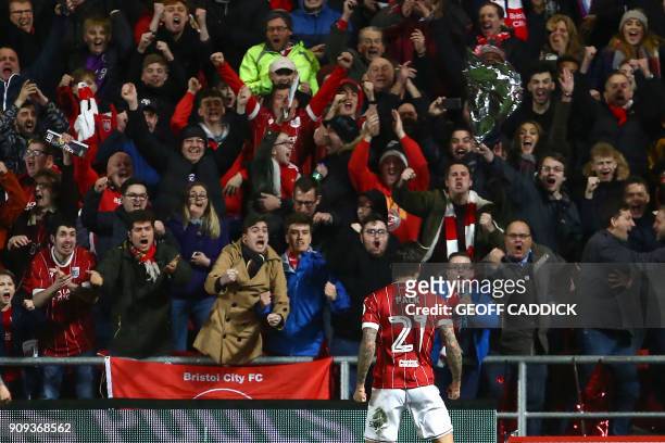 Bristol City's English midfielder Marlon Pack celebrates scoring their first goal with supporters during the English League Cup semi-final, second...