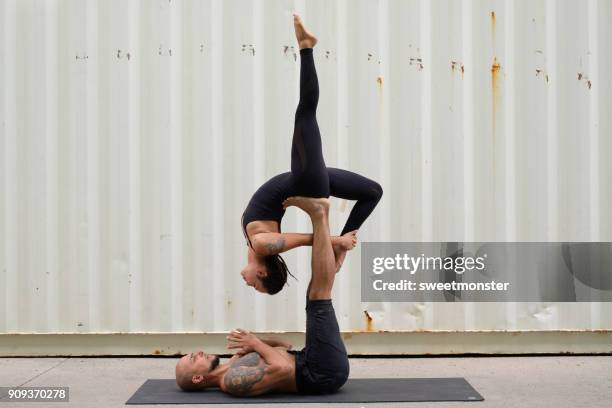 couple practicing acroyoga - acrobatic activity stock pictures, royalty-free photos & images
