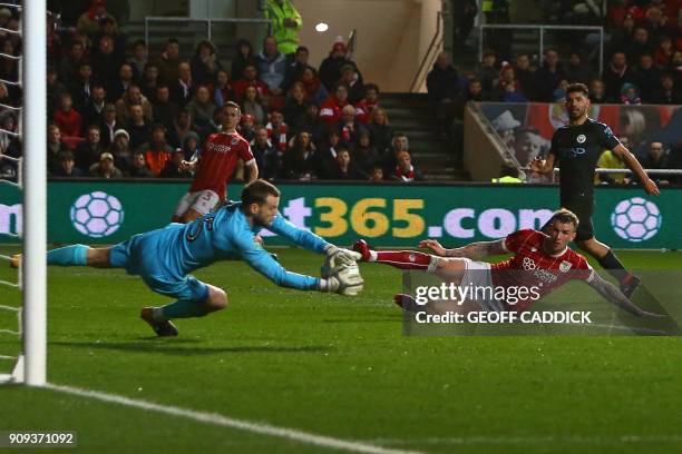 Bristol City's English goalkeeper Luke Steele makes a save during the English League Cup semi-final, second leg football match between Bristol City...