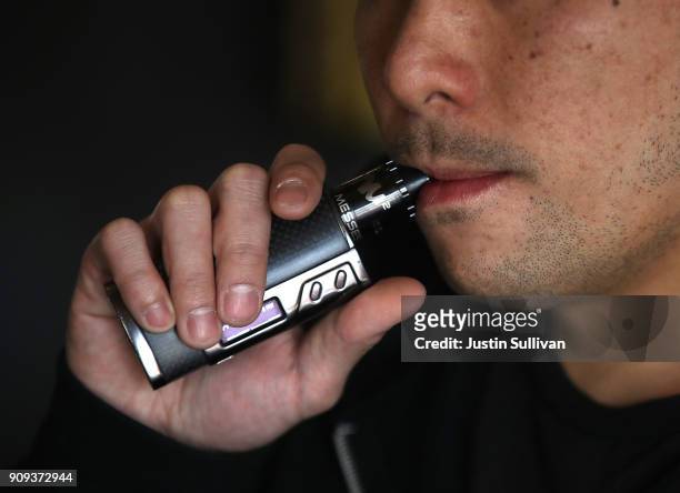 Jeremy Wong smokes an e-cigarette at The Vaping Buddha on January 23, 2018 in South San Francisco, California. According to a 600 page report by the...
