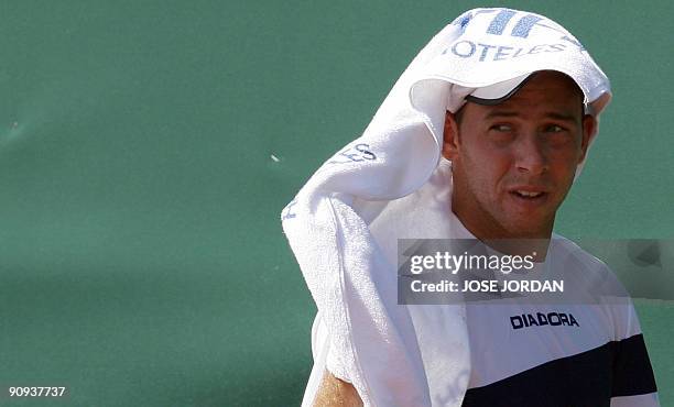 Israeli Dudi Sela uses a towel to protect his head from the sun during the second match of the Davis Cup semi-final tie between defending champions...