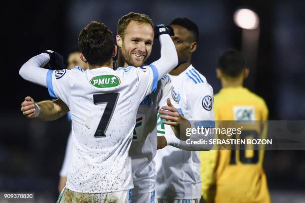 Olympique de Marseille's French forward Valere Germain is congratulated by teammates after scoring a goal during the French Cup football match...